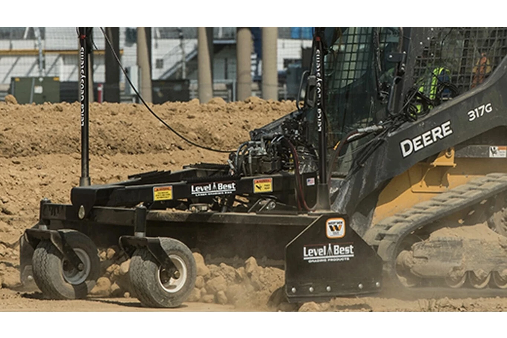 Box Blades with a tractor with a skid steer moving dirt in a construction site