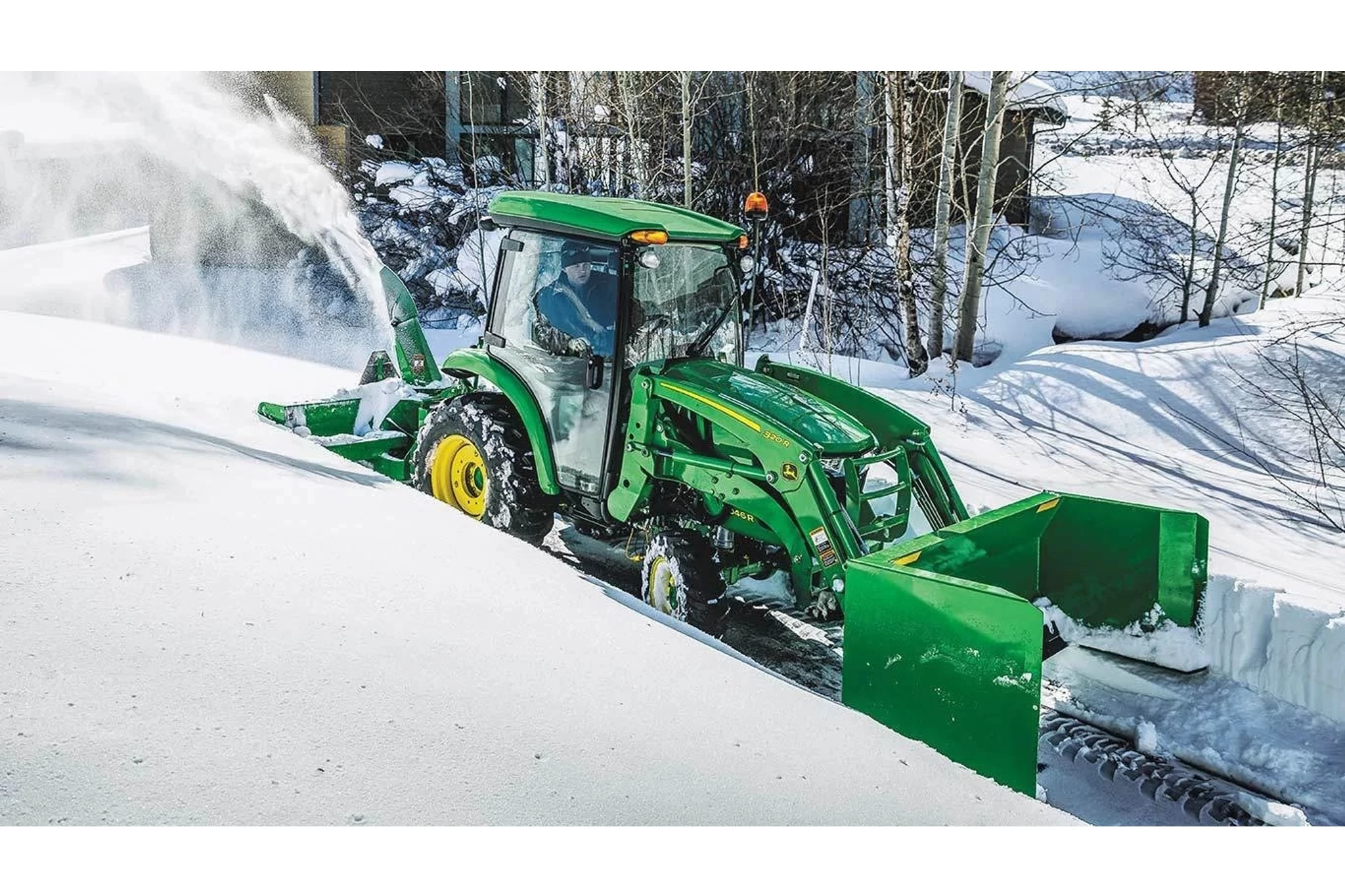 320R Front End Loaders with a snow plow blowing snow