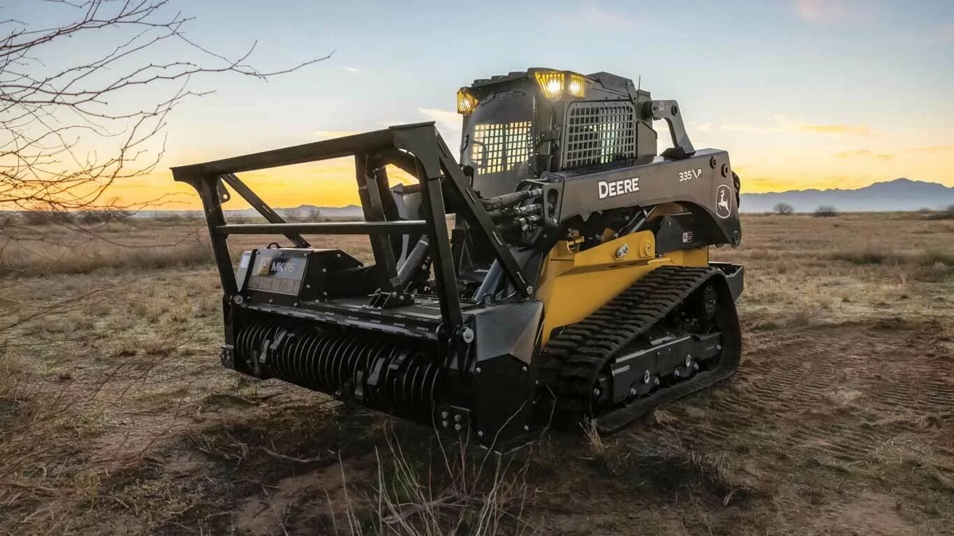 335 P-Tier Compact Track Loader with a close up of a tractor with a skid steer on a field