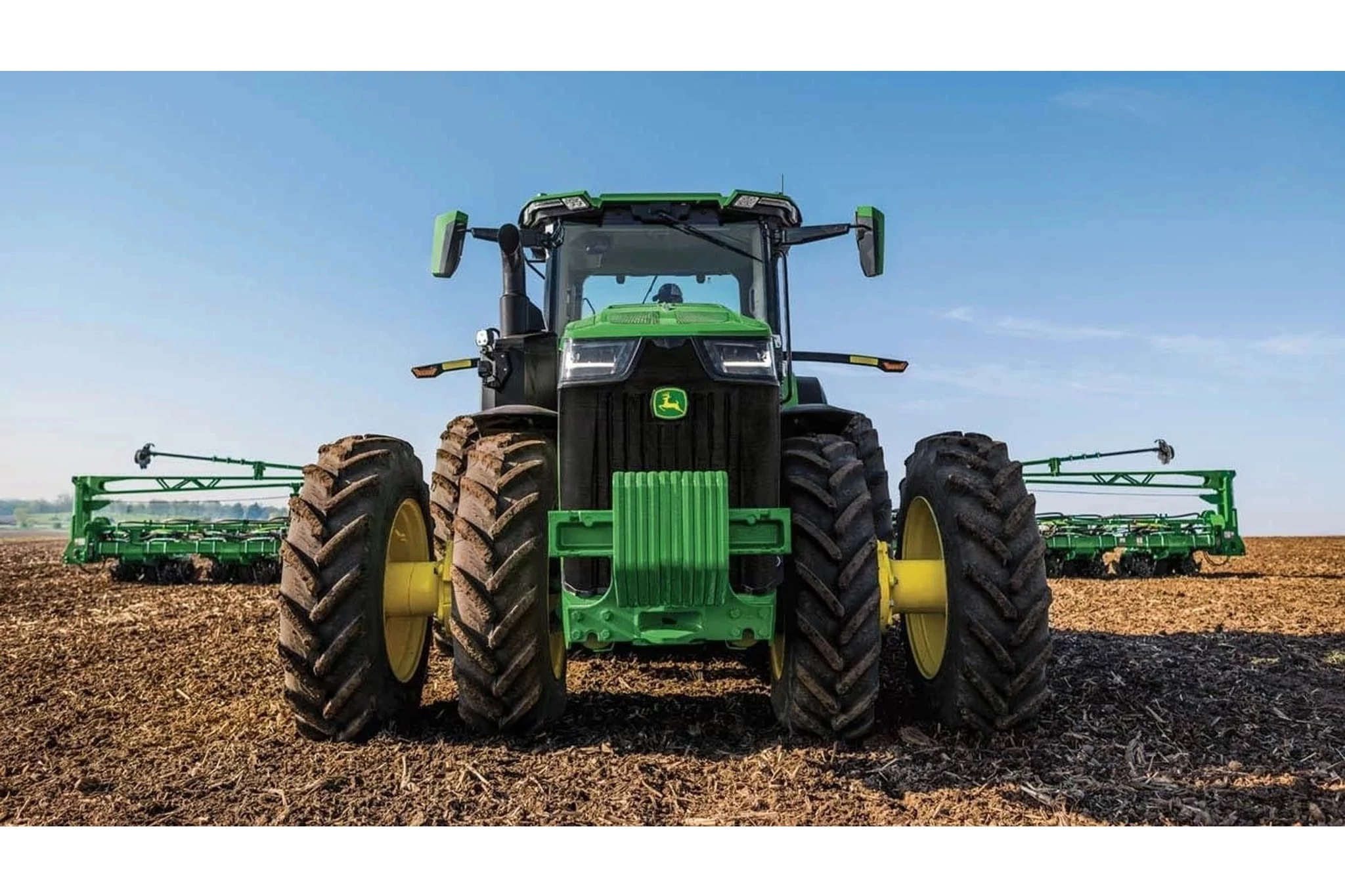 8R 370 Tractor in a corn field with tillage attachment.