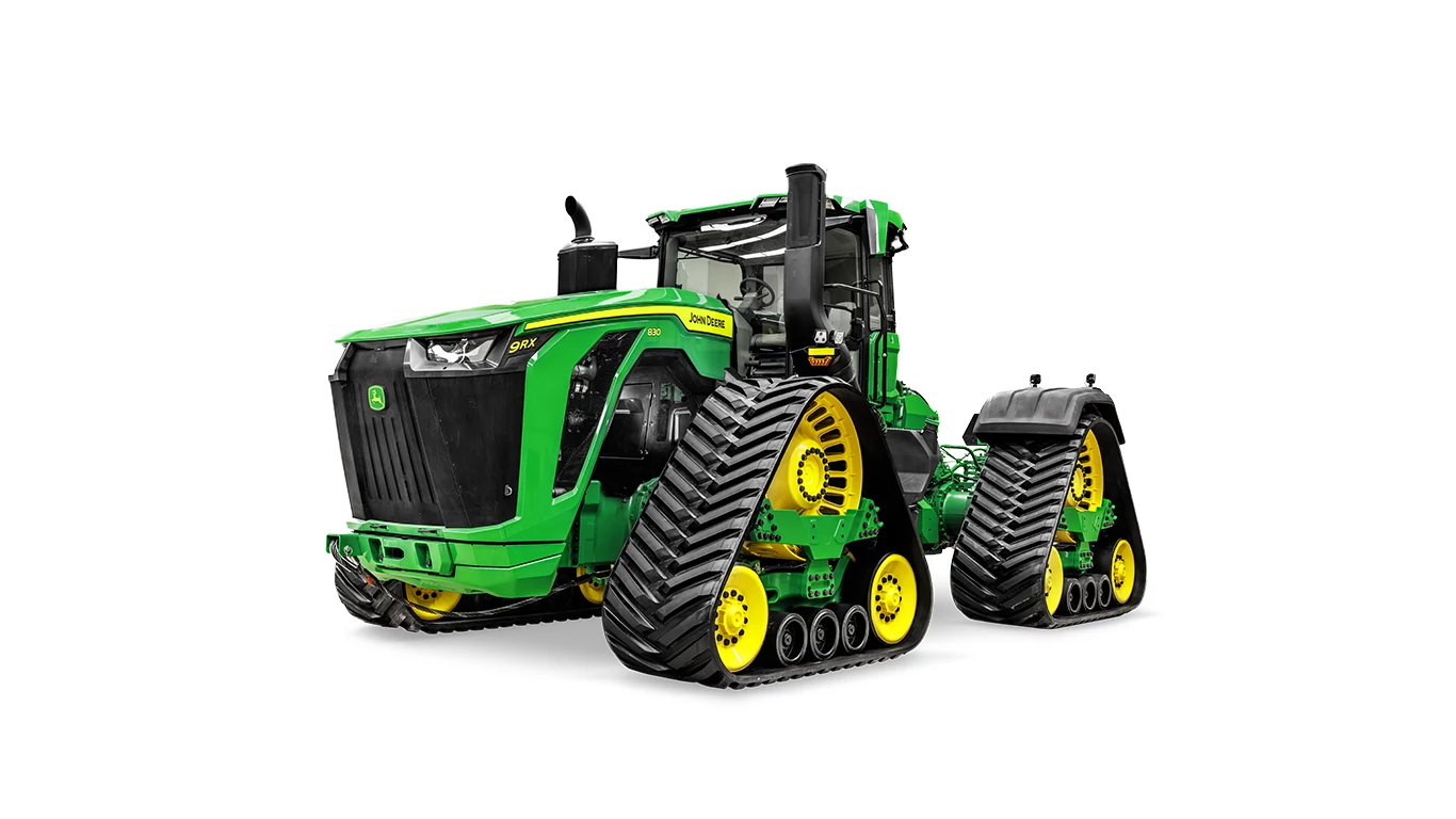 John Deere 9RX four‑track tractor shown from a front‑right angle on a white background, featuring independent rubber tracks and a full cab
