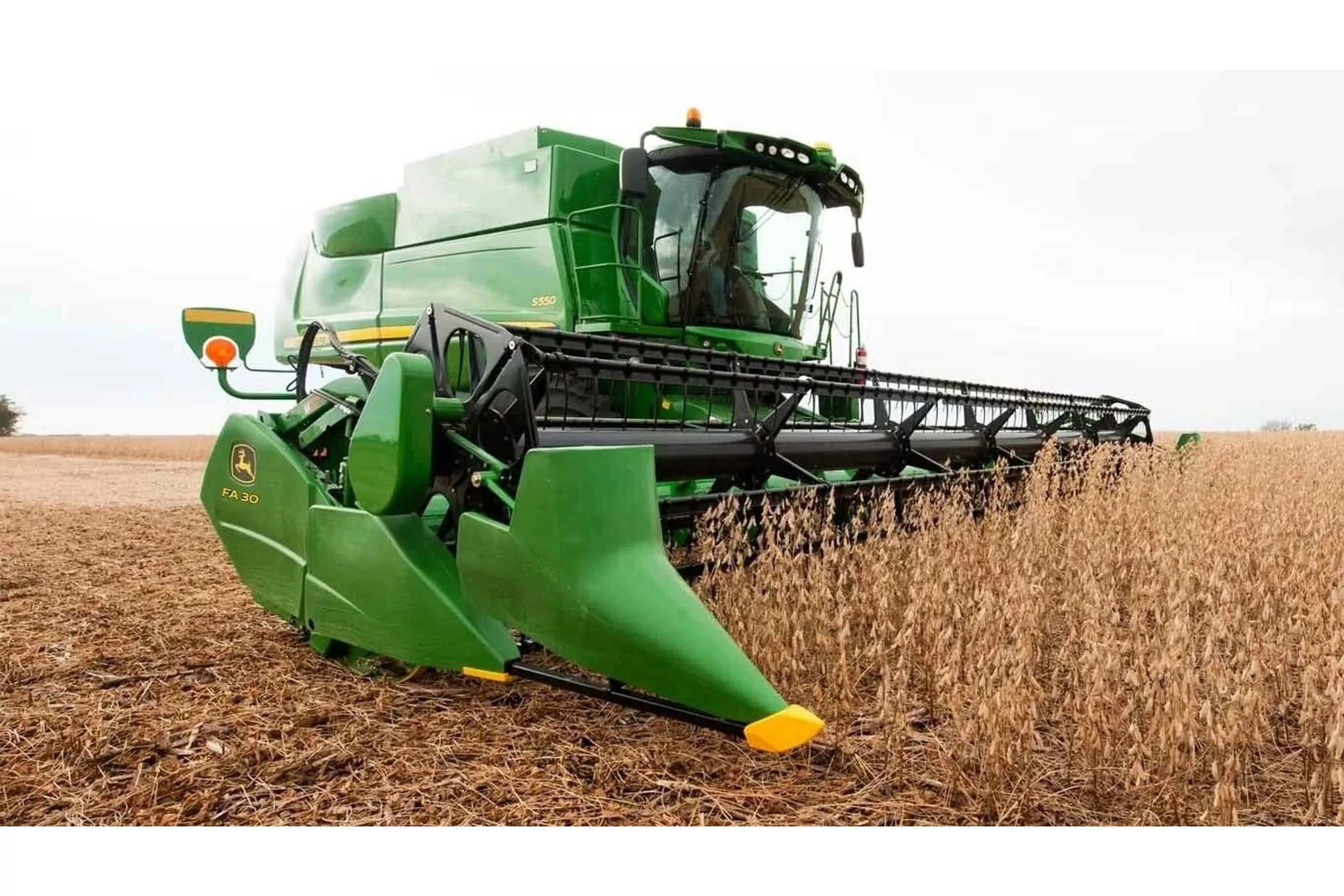 Front right view of a FA 30 Flex Auger Cutting Platform harvesting golden crop in a field