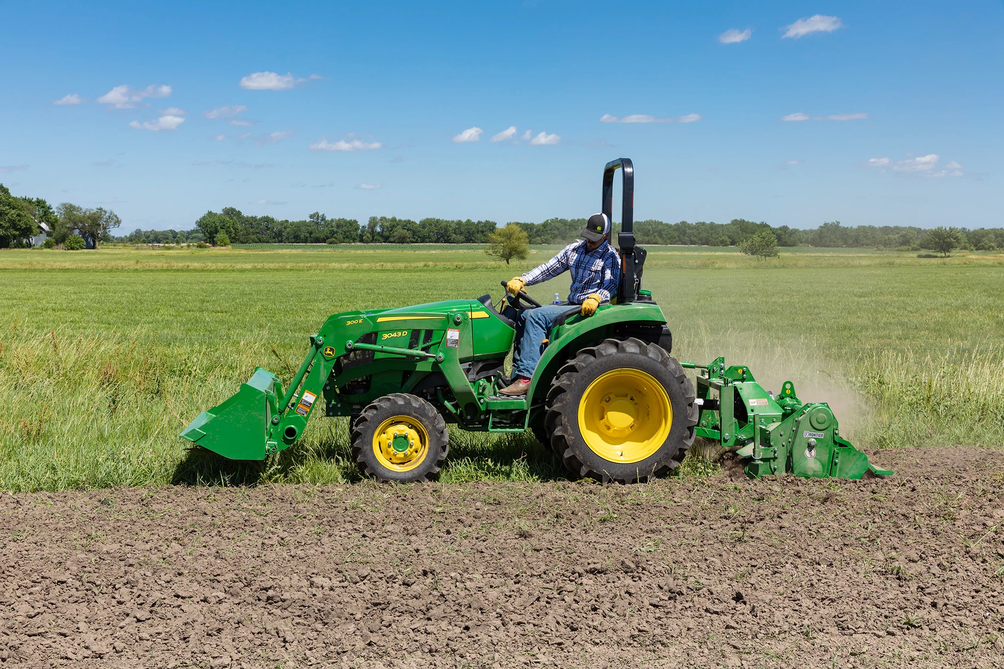 Field view of 3043D Tractor with RT3062 Rotary Tiller and 300E Bucket