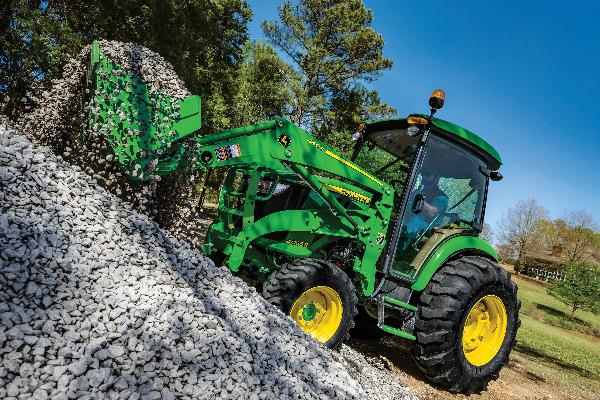 440R Loader moving rocks in field