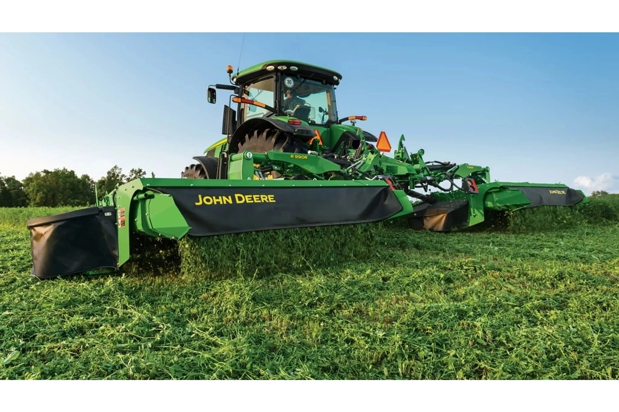R995R Rear Mount Mower-Conditioner mowing a field